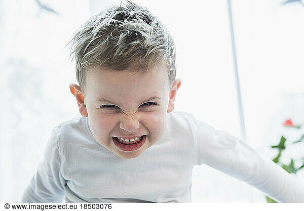 Close- up of little boy gritting his teeth in anger