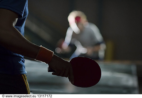 Close-up of man holding table tennis racket