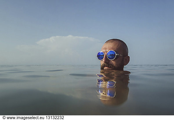 Close-up of man in sea against sky
