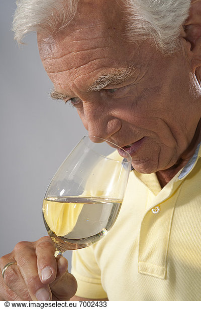 Close-up of Man Smelling Wine from Glass