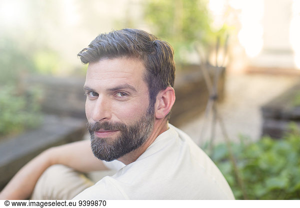 Close up of man smiling in backyard