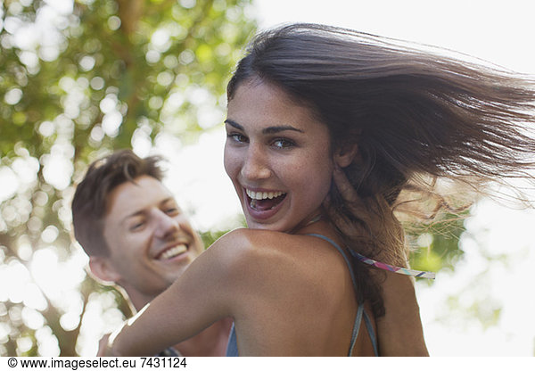 Close up of man spinning smiling girlfriend