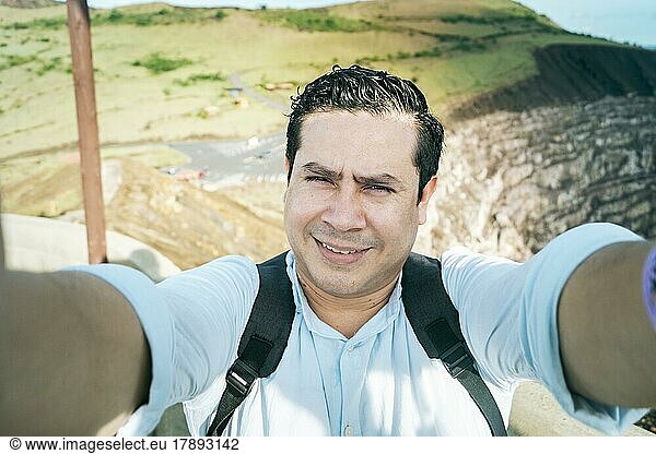 Close up of man taking an adventure selfie  Tourist taking a selfie at a viewpoint. Adventurous people taking a selfie at a viewpoint. Handsome tourist taking a selfie on vacation