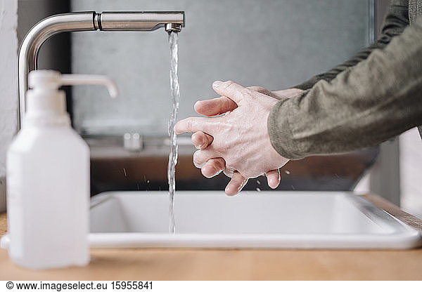 Close-up of man washing his hands