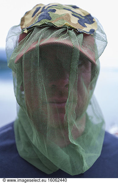 Close up of man wearing protective mosquito netting