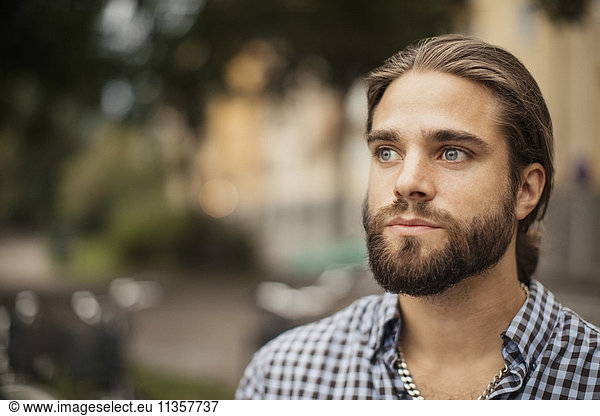 Close-up of man with beard looking away