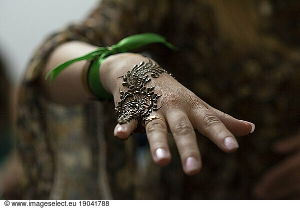 Close up of painted hand woman with henna in a party in Morocco.
