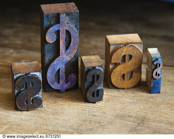 Close up of printing blocks with dollar sign on wood