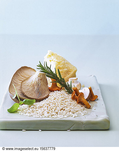 Close-up of raw ingredients for cooking Risotto on table against wall