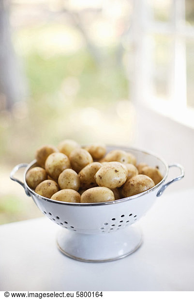 Close-up of raw potatoes in colander