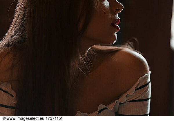 Close-up of red lips illuminated by light