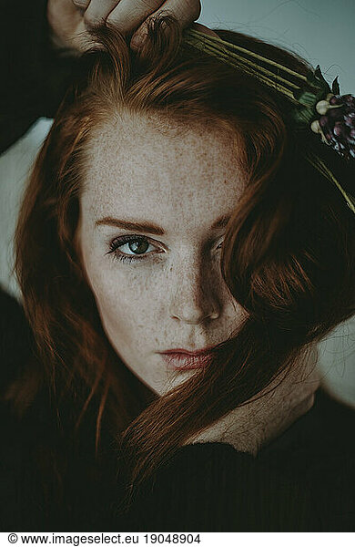 Close up of Redheaded Woman with Flowers
