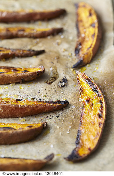 Close-up of roasted sweet potato slices on table