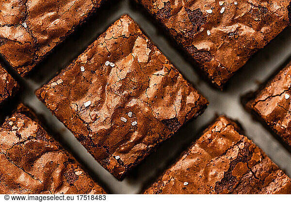 Close up of salted chocolate brownies cut into squares.