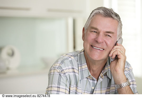 Close up of senior man talking on telephone