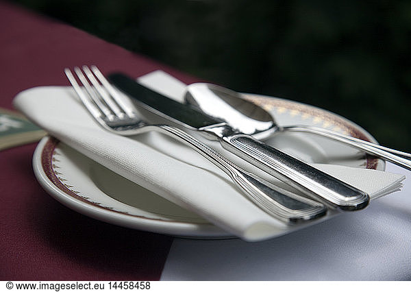 Close up of silverware and cloth napkin on fine china