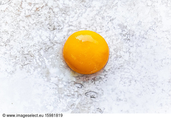 Close-up of single egg yolk