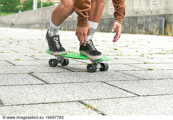 Close-up of Skateboarder doing a trick at the park. Concept of leisure activity  sport  extreme  hobby and motion.