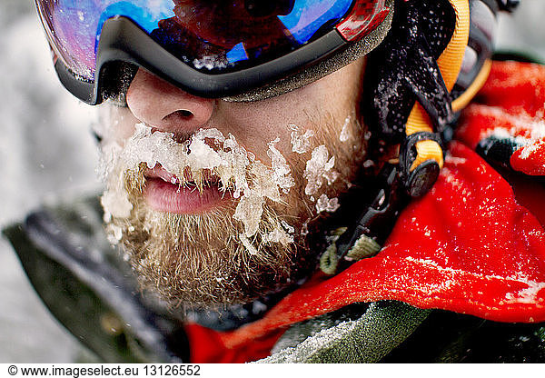 Close-up of skier with snow on mustache