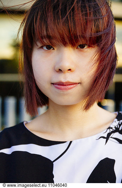 Close up of smiling Chinese woman in wind