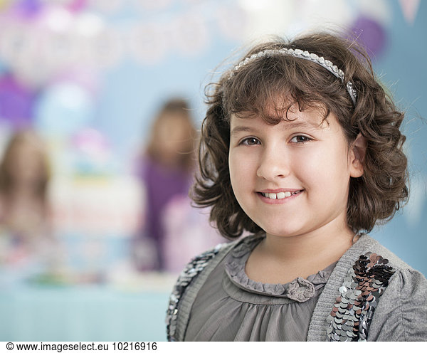Close up of smiling girl at birthday party