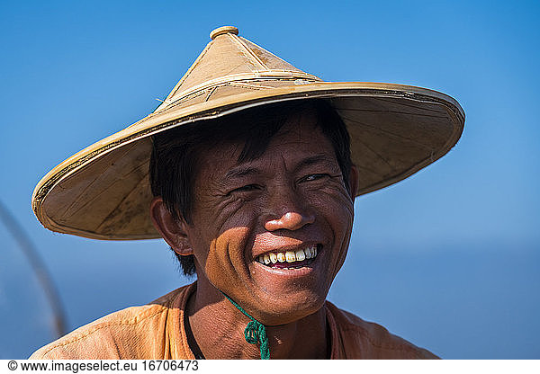 Close-up of smiling Intha fisherman against clear blue sky  Lake Inle  Nyaungshwe  Myanmar
