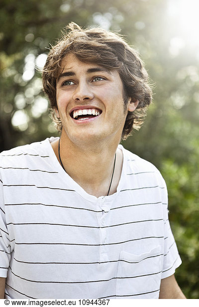 Close up of smiling young man looking away