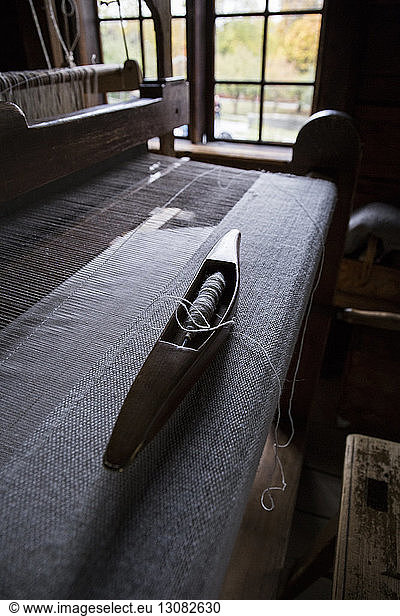 Close-up of spool and loom in textile industry