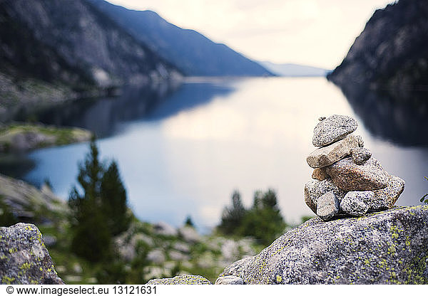 Close-up of stack of stones against lake