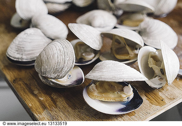 Close-up of steamed clams on wet wooden table