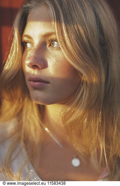 Close-up of sunlight falling on teenage girl