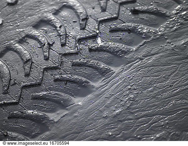 close up of SUV tyre tracks in grey mud