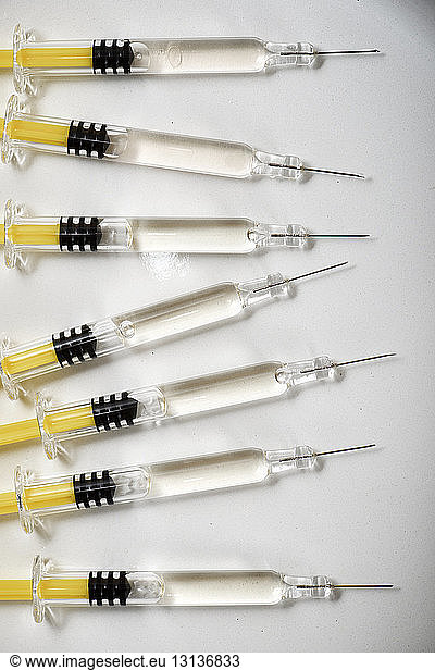 Close-up of syringes in row on table at hospital