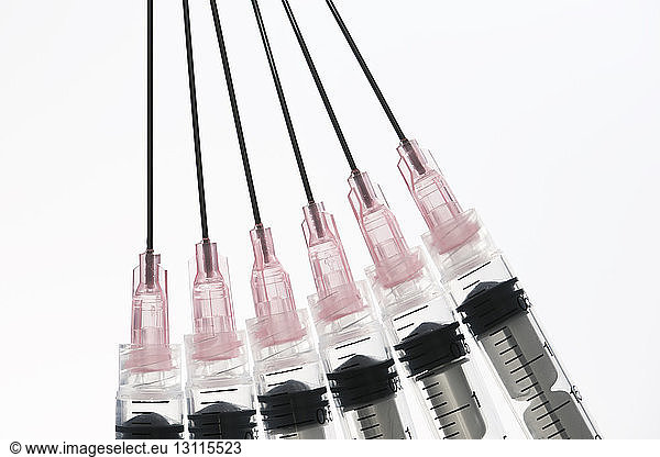 Close-up of syringes on white background