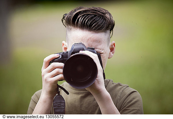 Close-up of teenage boy photographing