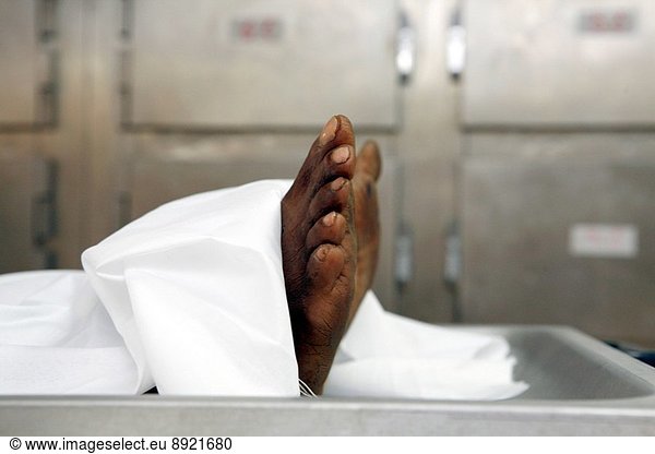 Close up of the feet of a corpse in a mortuary.