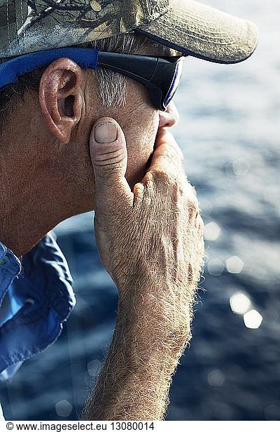 Close-up of thoughtful man travelling on sea