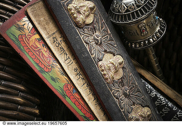 Close-up of Tibetan prayer holders and a prayer wheel.