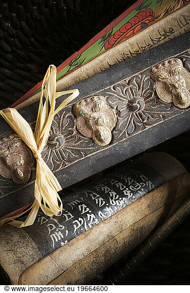 Close-up of Tibetan prayer holders and a prayer wheel.