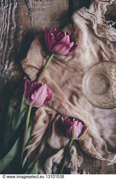 Close-up of tulips and textile on table