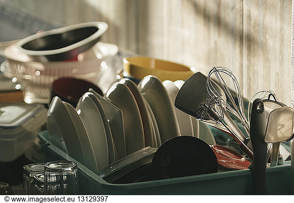 Close-up of utensils in bucket on kitchen counter at home