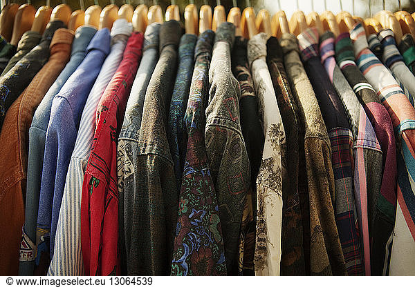 Close-up of various shirts hanging in clothes rack