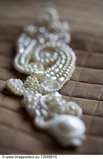 Close-up of wedding jewelry on textile