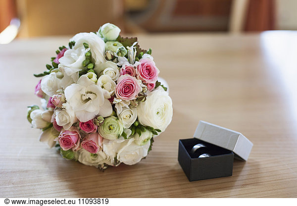 Close-up of wedding ring with bridal bouquet