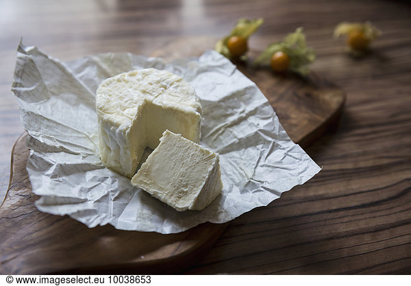 Close-up of white cheese with slice on chopping board  Germany