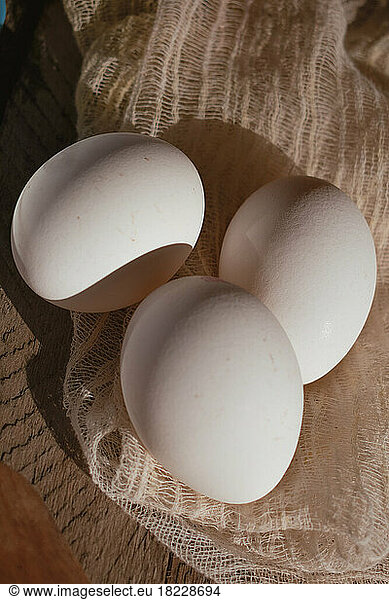 Close-up of white eggs on a napkin.