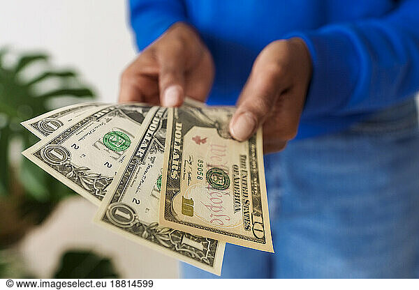 Close-up of woman holding paper currency
