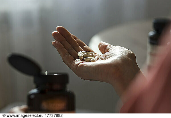 Close-up of woman holding pills
