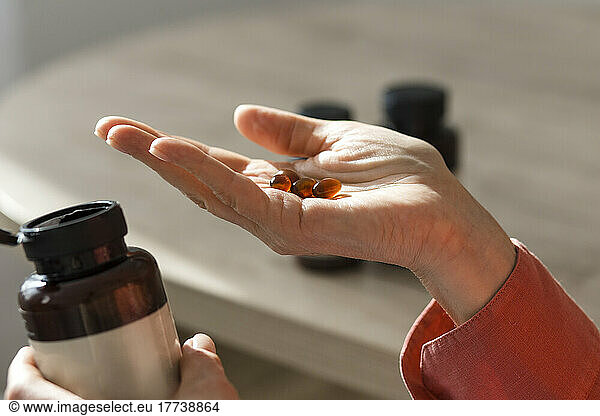 Close-up of woman holding pills