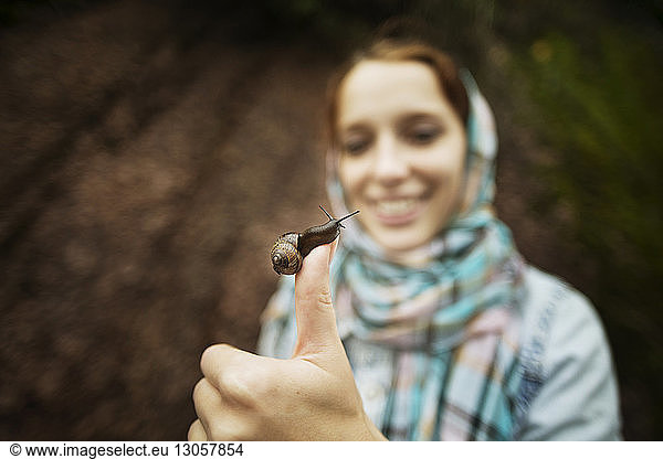 Close-up of woman holding snail